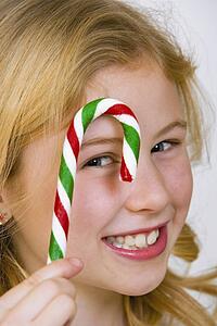 Young girl holding a candy cane