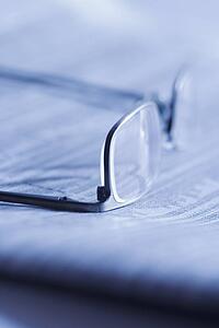 Glasses on newspaper