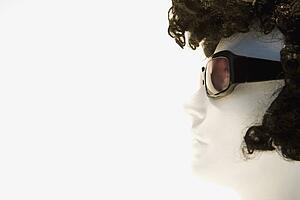 Mannequin with curly brown wig and sunglasses