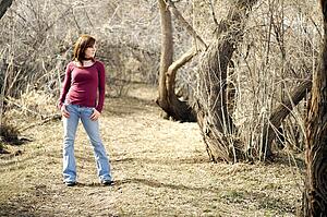 Young woman posing in a wooded area