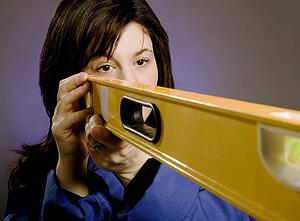 Woman holding a spirit level