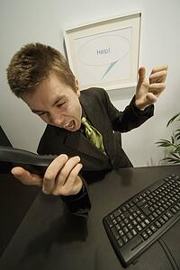 Businessman screaming into a phone
