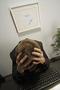 High angle view of a businessman with his head in his hands