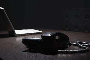 Telephone and laptop on a table