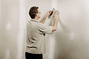 Man using a putty knife