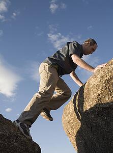 Man climbing up rocks