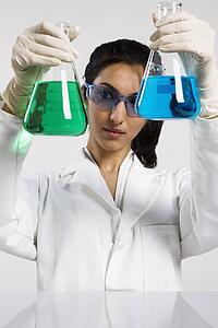 Woman holding two beakers up