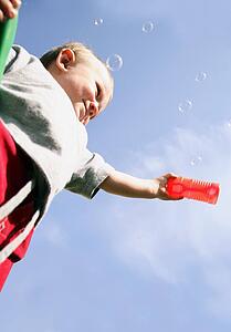 Little boy playing with bubbles