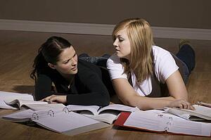 Two women studying on the floor
