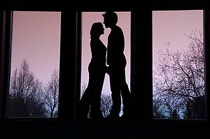 Silhouette of couple standing face to face