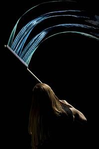 Person waving flag in black background