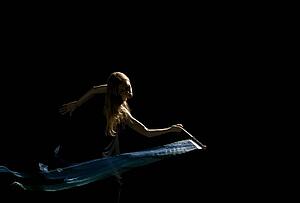 Woman waving flag in black background