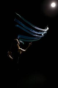 Woman waving flag in spotlight