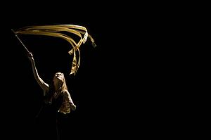 Woman waving flag in black background
