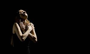 Woman with arms crossed and face up