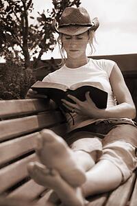Woman reading the Bible with reflection of words on her face