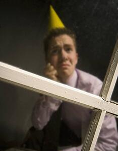 Sad man in party hat
