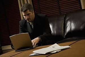 Businessman working on his laptop on the coffee table