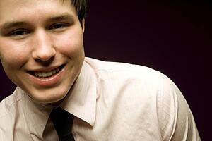 Young man smiling in shirt and tie