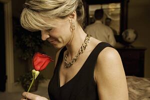 Woman smelling a red rose