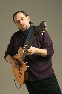 Middle aged man playing the guitar