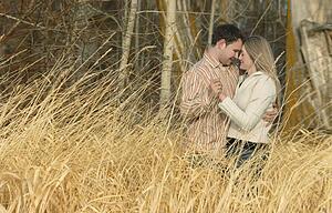 Couple holding each other in a field of wheat