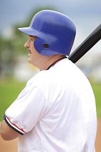 Baseball player holding bat, ready to hit