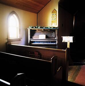 Chapel with wooden benches and organ in the corner