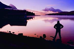 Silhouette of a man at a mountain lake 