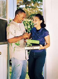 Couple laughing over spilled paint