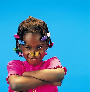 African little girl with arms crossed and a butterfly on her nose