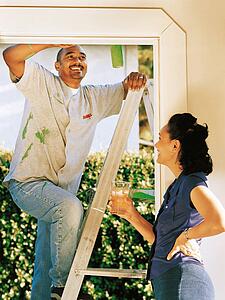 Couple painting doorway