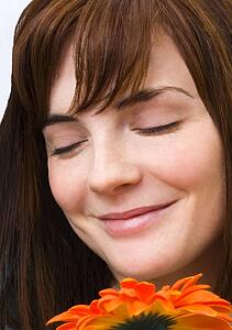 Woman enjoying smell of flower