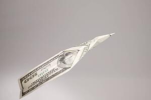 A one hundred dollar bill floating through the air