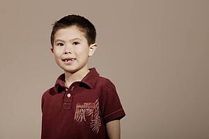 Little boy smiling and posed wearing red shirt