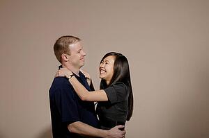 A man and woman embracing and laughing