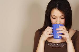 Woman drinking a hot drink