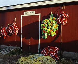 Fishing buoys hanging on an outside wall