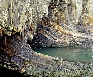 Rocky cave with water flowing into it