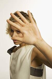 Woman holding her hand up and glaring