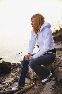 Woman sitting on rock at a beach