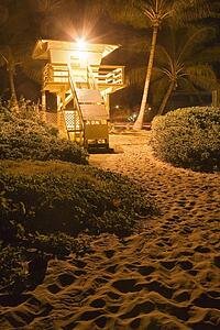 A lifeguard hut on the beach at night