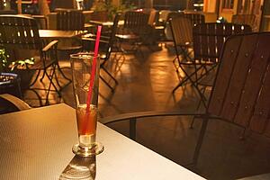Drink in a glass with straw in an empty restaurant