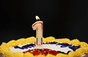 A birthday cake with lit candle