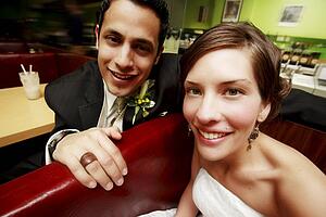 A couple smiling and sitting