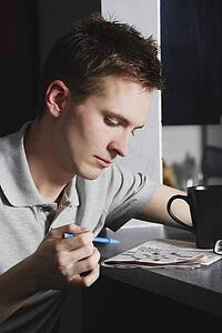 Man working on a crossword