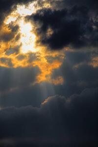 Sun piercing through clouds