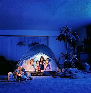 Children holding torches in a tent