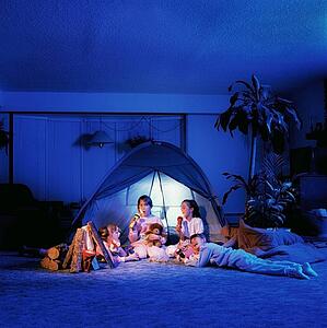 Children playing under a tent in the living room