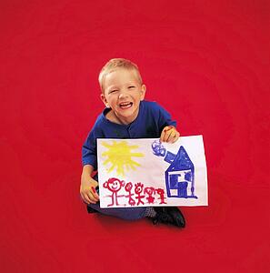 Child posing and holding painting